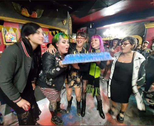 Artists and guests celebrating inside Strata Tattoo Lab